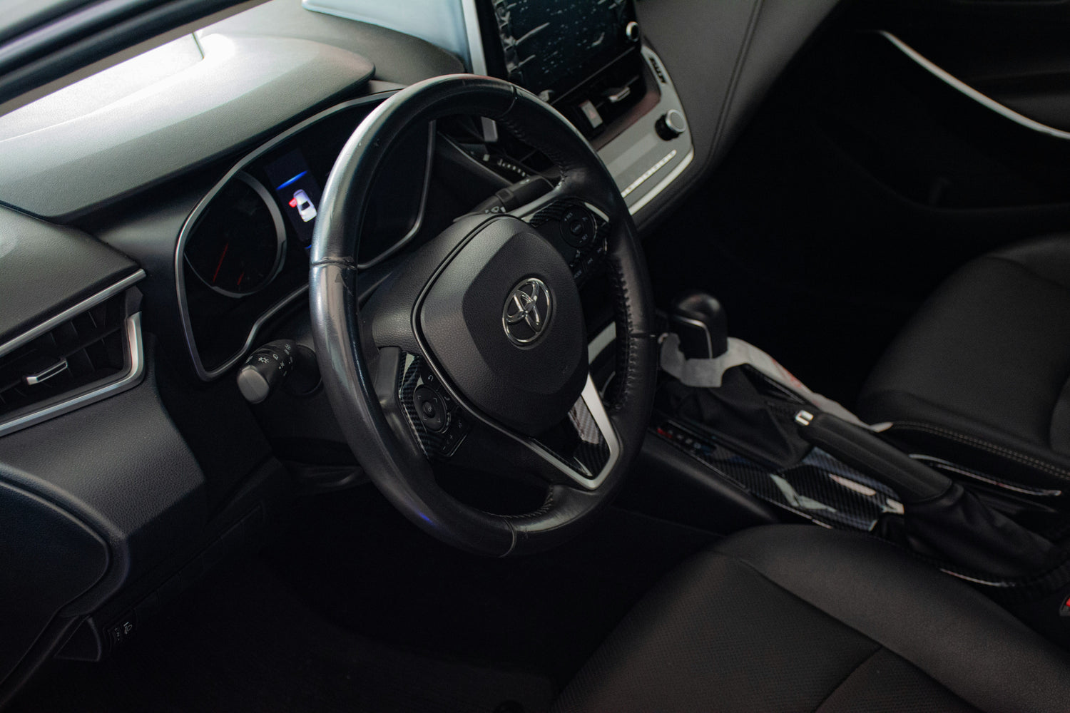 Image showing the interior of a car highlighting the automatic gear selector and power steering wheel